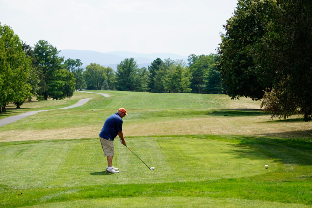 Golf teeing off during a Timber Ridge School Benefit Golf Tournament at Shenandoah Valley Golf Club