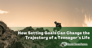 How Setting Goals Can Help Teenagers. Boy climbing a mountain.